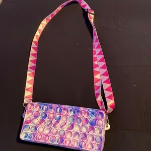 Selling a very good condition pop it purse-comes with strap.